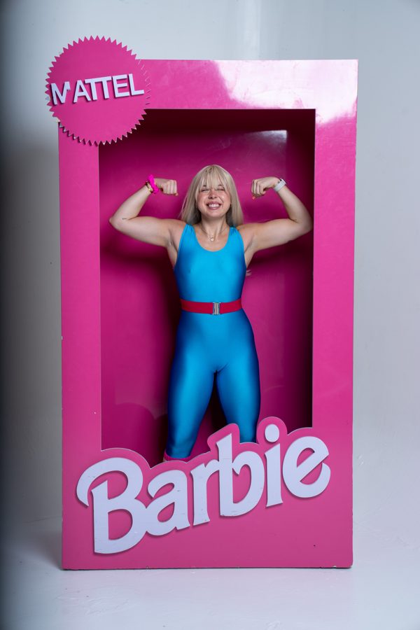 Member flexing inside a life-size Barbie box