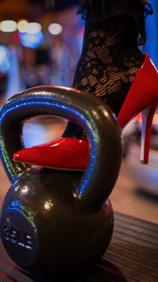 Red stiletto resting on a 35 lb kettlebell