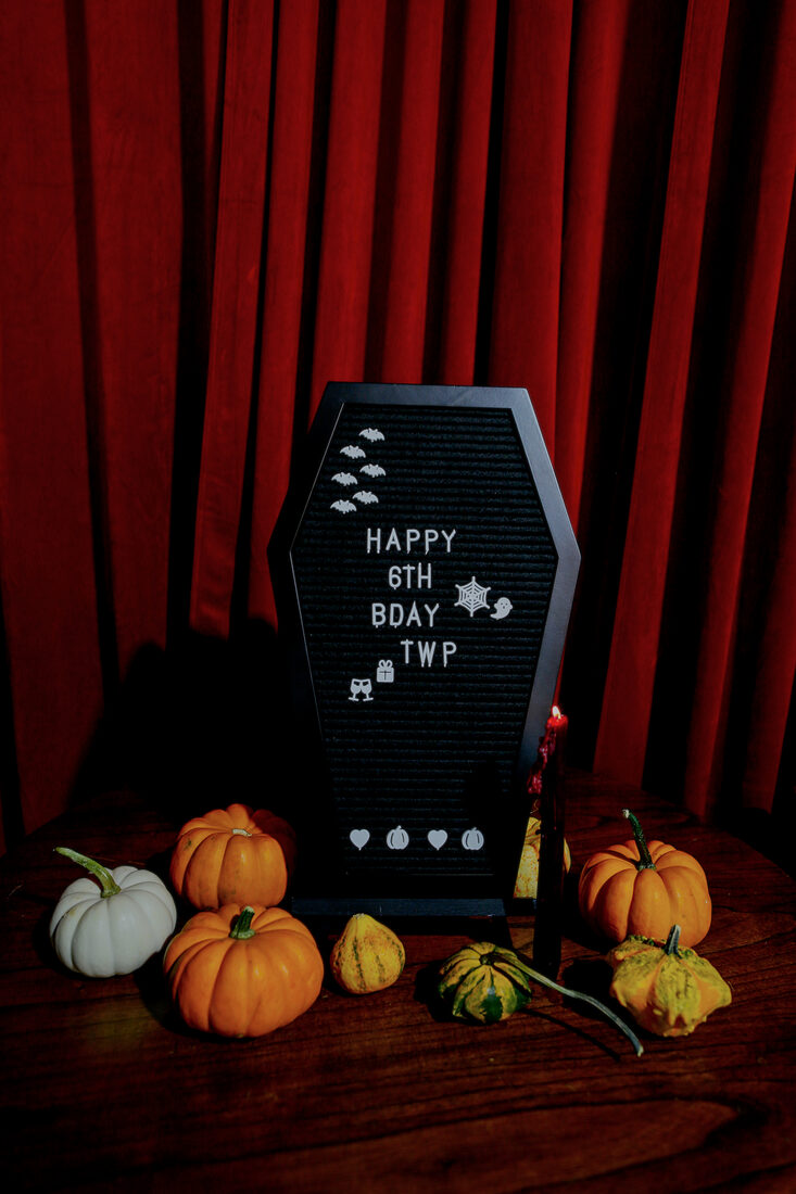 Coffin letterboard reading happy 6th birthday TWP surrounded by pumpkins
